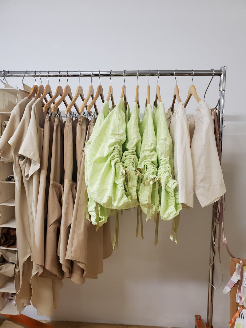 rack of clothing featuring the Yessenya Spring collection by designer Bris Carbajal