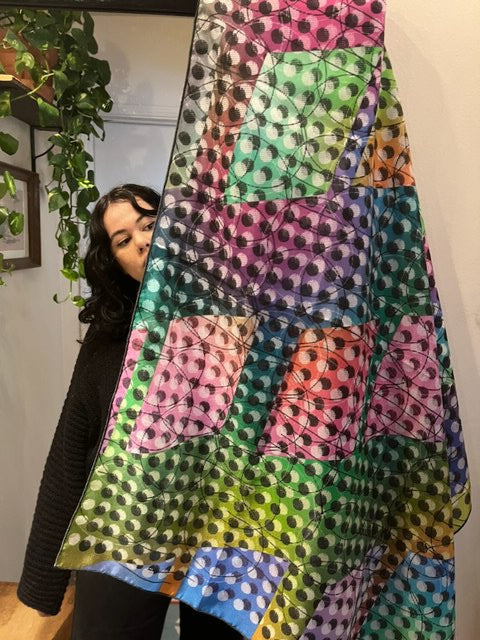 Portrait of Kim Mejia with one of her silk scarf designs