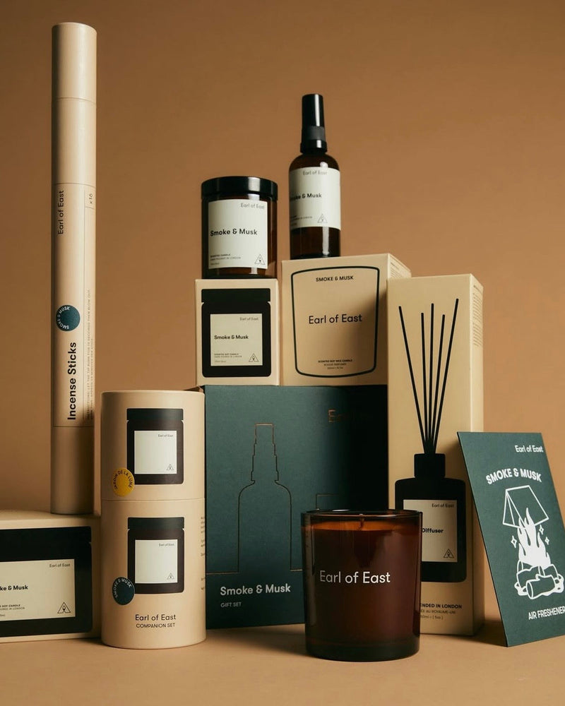 Stack of packaged products in dark green and Kraft cardboard boxes with Earl of East branding