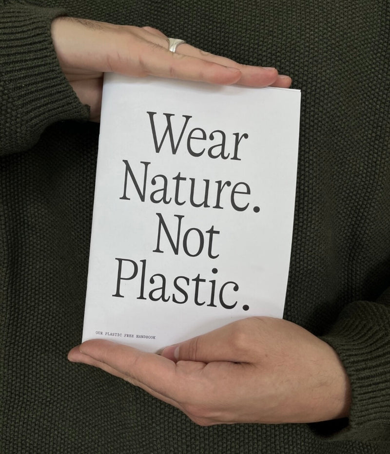 Hands holding a Wear Nature. Not Plastic. booklet 