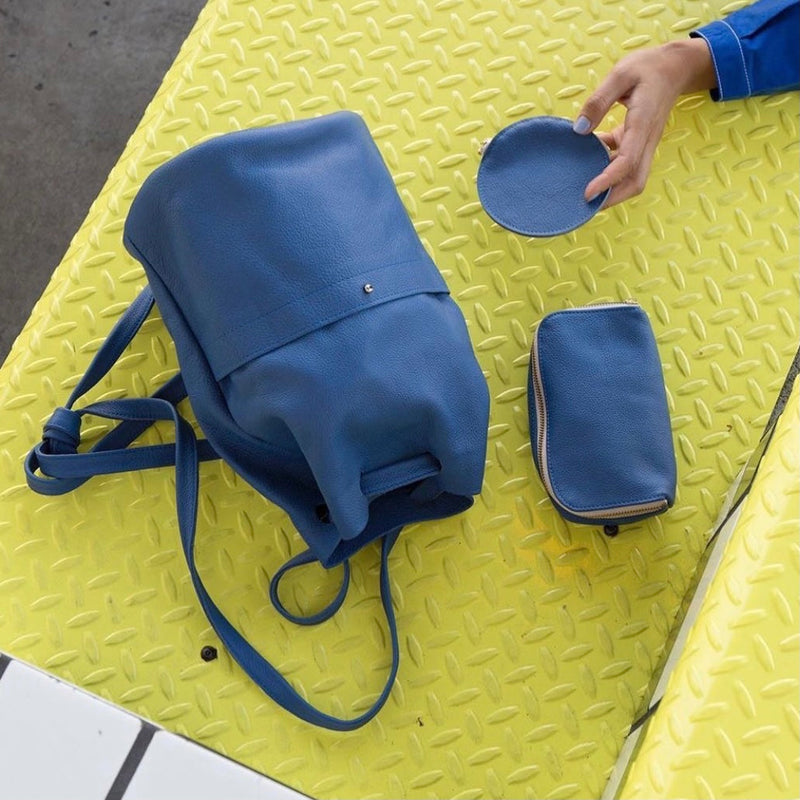 Blue leather backpack and accessories by Erin Templeton