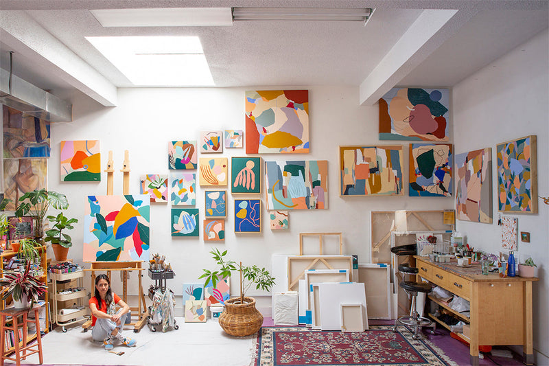 Artist Fernanda Martinez in her art studio with paintings