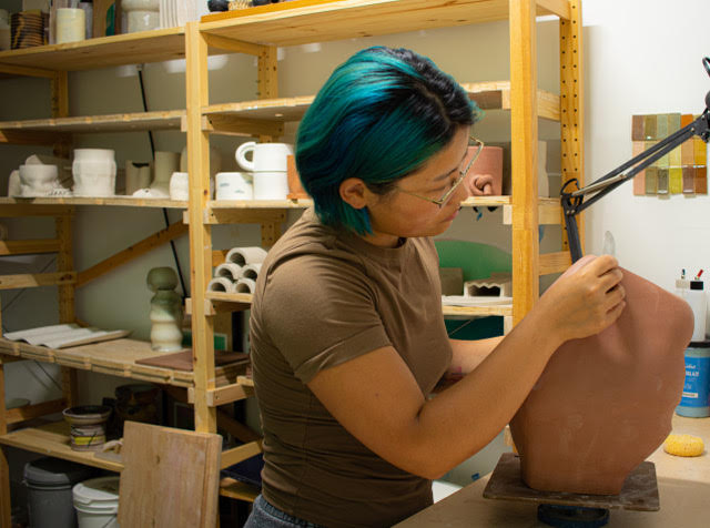 Artist Yue Zhou working on ceramics