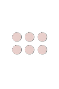 Set of six pink circular magnets on a white background