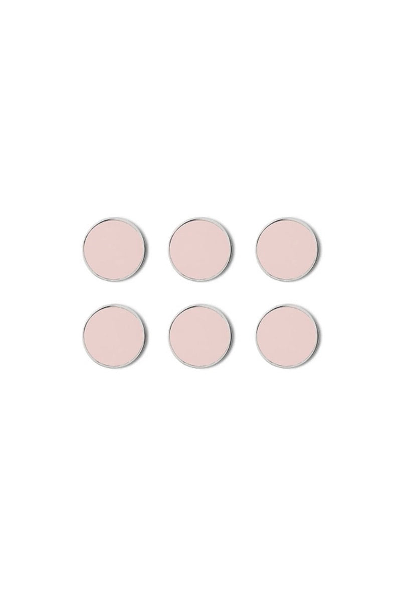 Set of six pink circular magnets on a white background