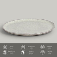 Round ceramic plate with speckled texture on a gray background, featuring icons and text about safety and features.