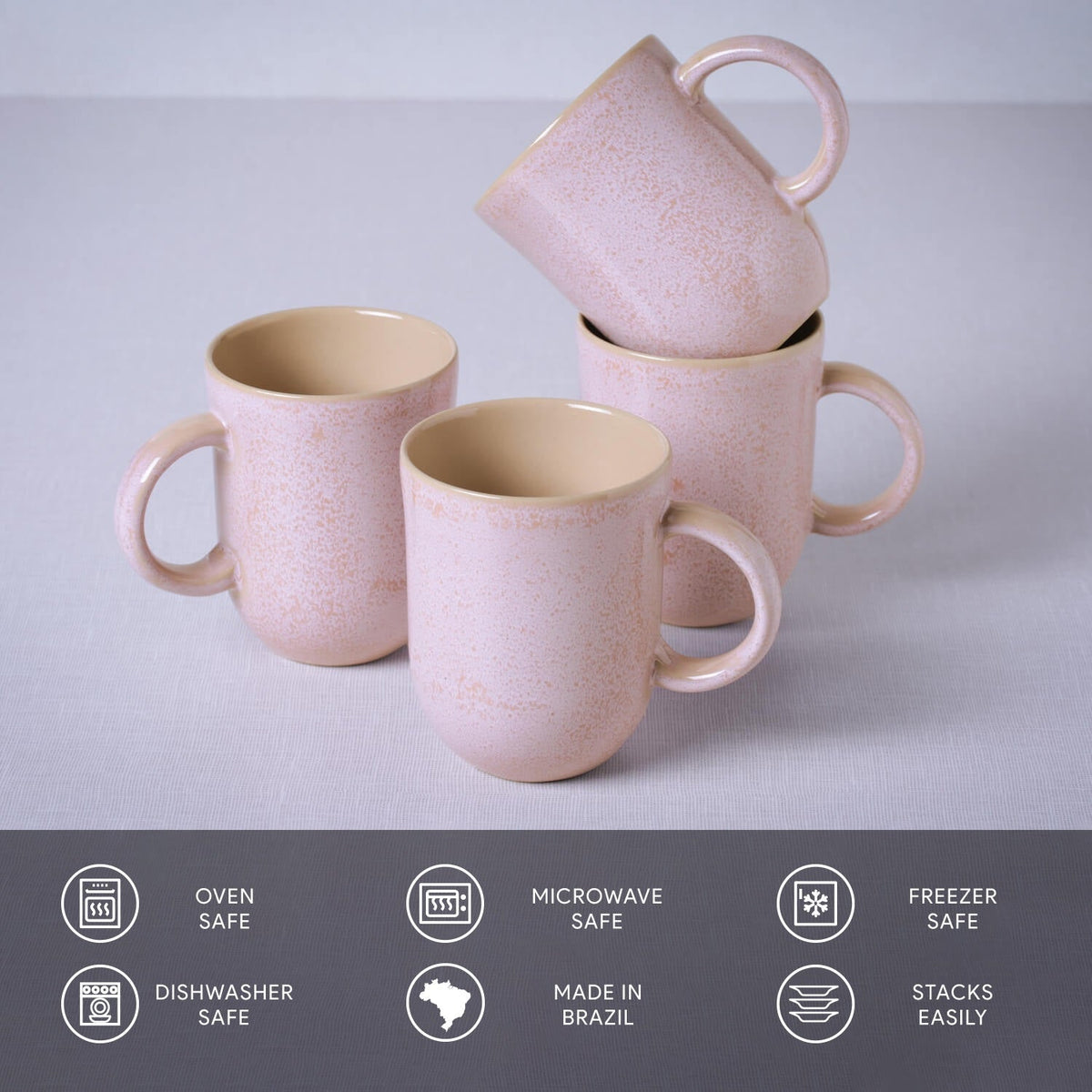 Set of pink ceramic mugs with handles on a light gray background