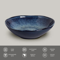 Blue ceramic bowl on a gray background with safety and feature icons at the bottom.