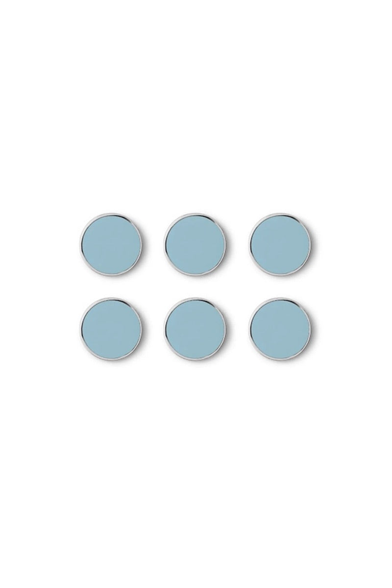 Set of six light blue circular magnets on a white background