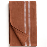 Rust color textured bath towel with white stripes