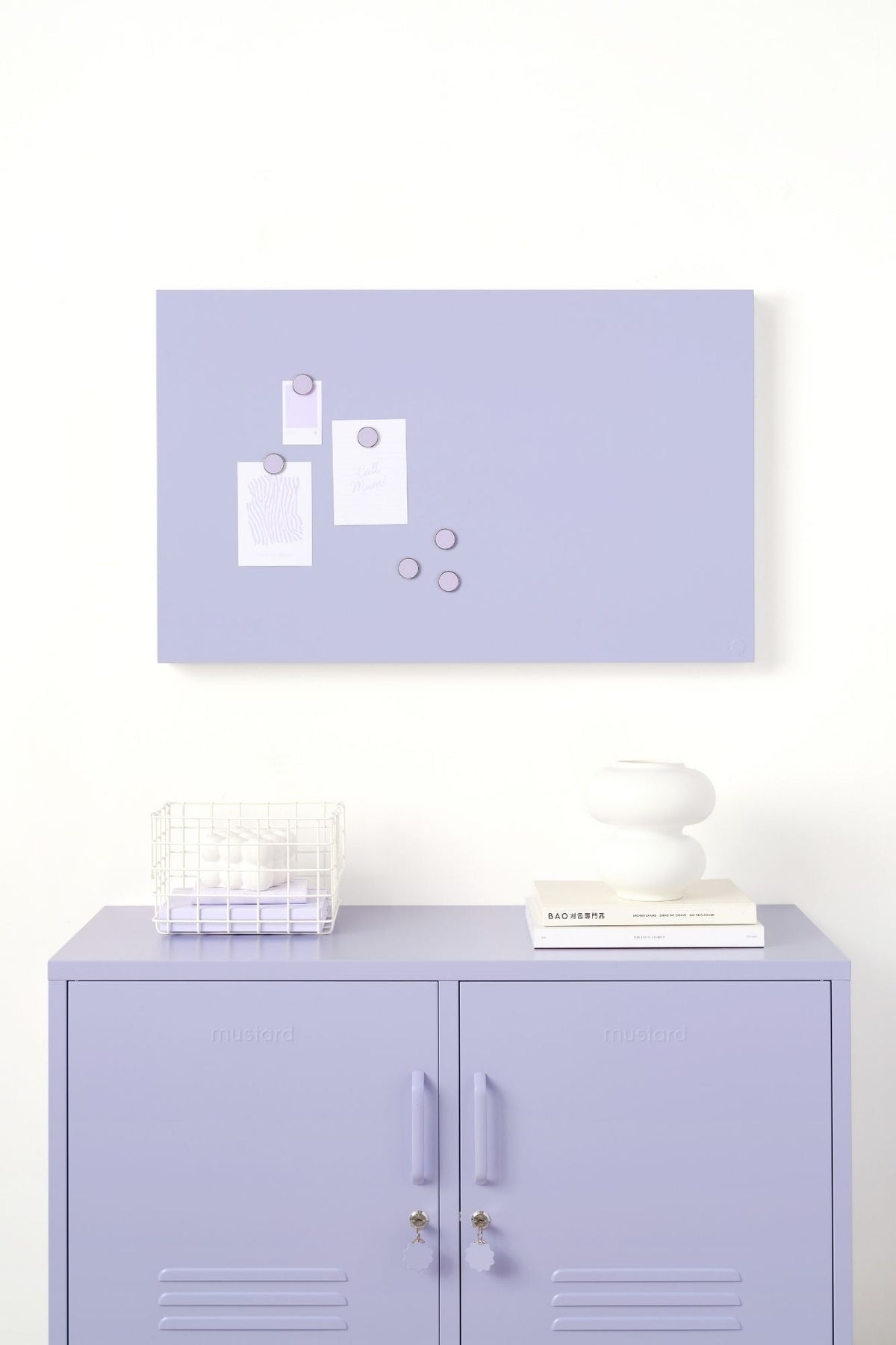 Purple locker cabinet with a matching purple wall-mounted board featuring white magnetic items on a white background