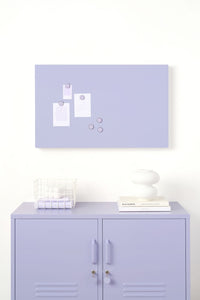 Purple locker cabinet with a matching purple wall-mounted board featuring white magnetic items on a white background