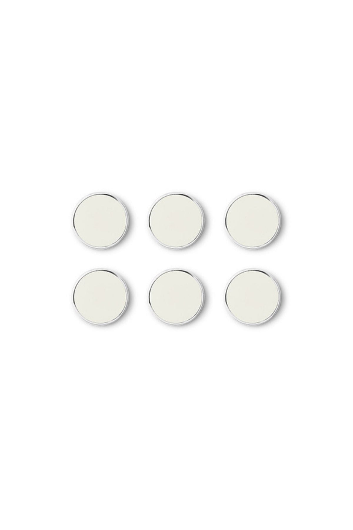 Set of six round white magnets with silver trim on a white background