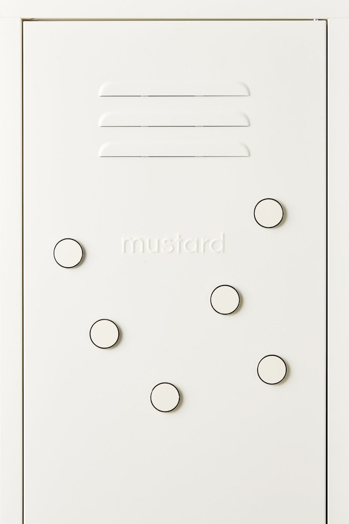 White locker door with circular magnets and 'mustard' branding.