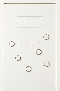 White locker door with circular magnets and 'mustard' branding.