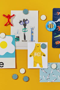Colorful children's pictures and magnets on a yellow board background