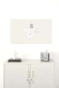 White locker-style cabinet with a lamp, basket, and decorative items on a white board background