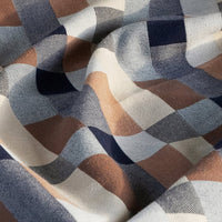 Close-up of checkered blanket with brown, blue, and beige pattern