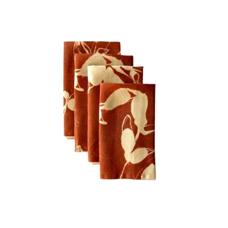 Set of four floral-patterned napkins on a white background