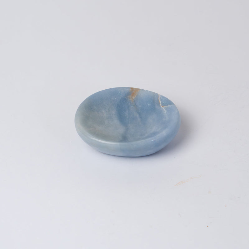 Light blue stone dish on a white background