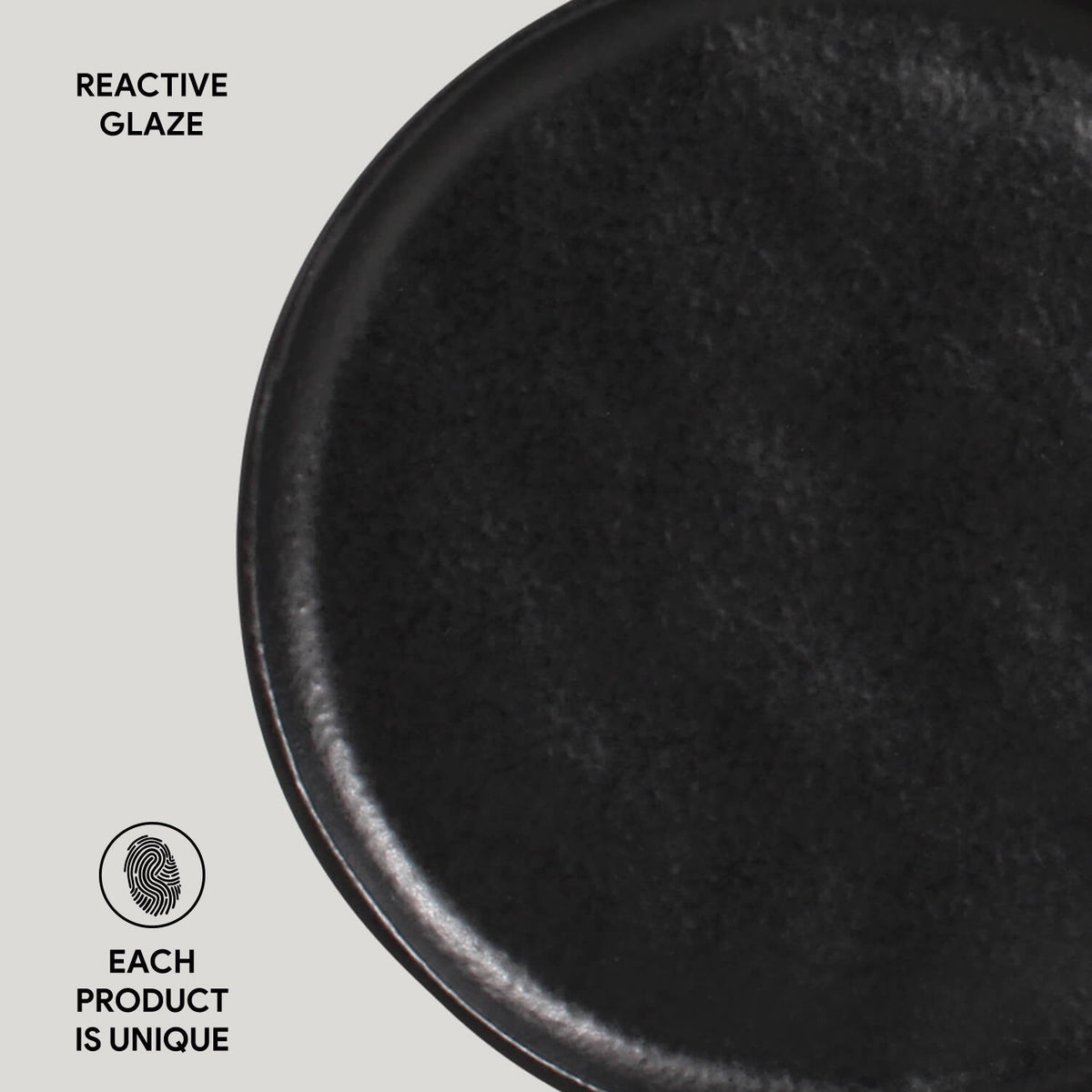 Close-up of a black ceramic product with 'Reactive Glaze' text and 'Each Product is Unique' label on a light gray background.