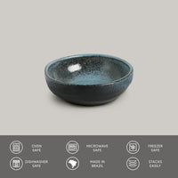 Blue ceramic bowl on a gray background with safety and feature icons at the bottom.