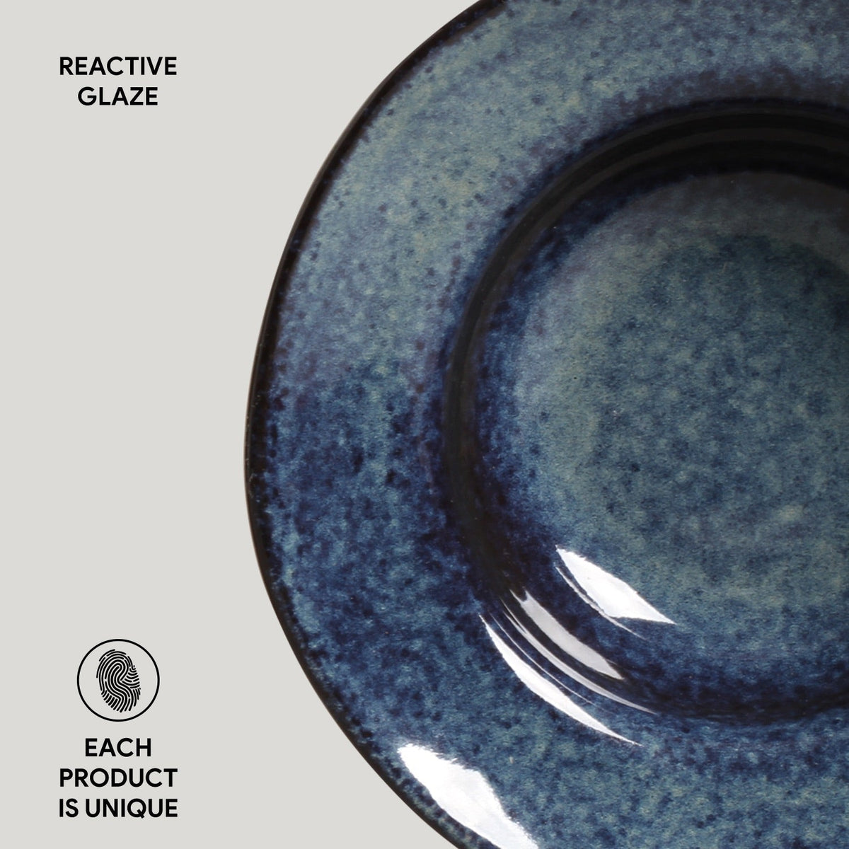 Blue ceramic dish with reactive glaze on a light gray background