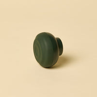Green spherical object on a beige background
