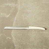 bread knife on a natural concrete surface