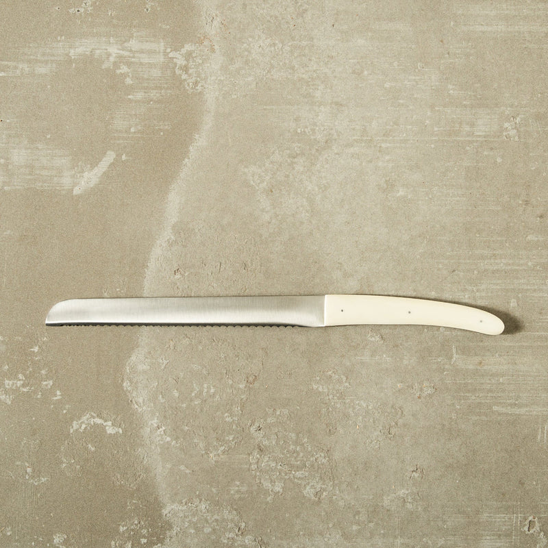 bread knife on a natural concrete surface