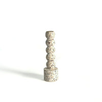 Speckled terrazzo candle holder on a white background