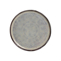 Round ceramic plate with a speckled design on a white background