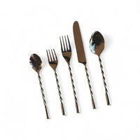 Set of silver cutlery with twisted handles on a white background
