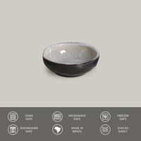 Black ceramic bowl on a gray background with safety and feature icons below.