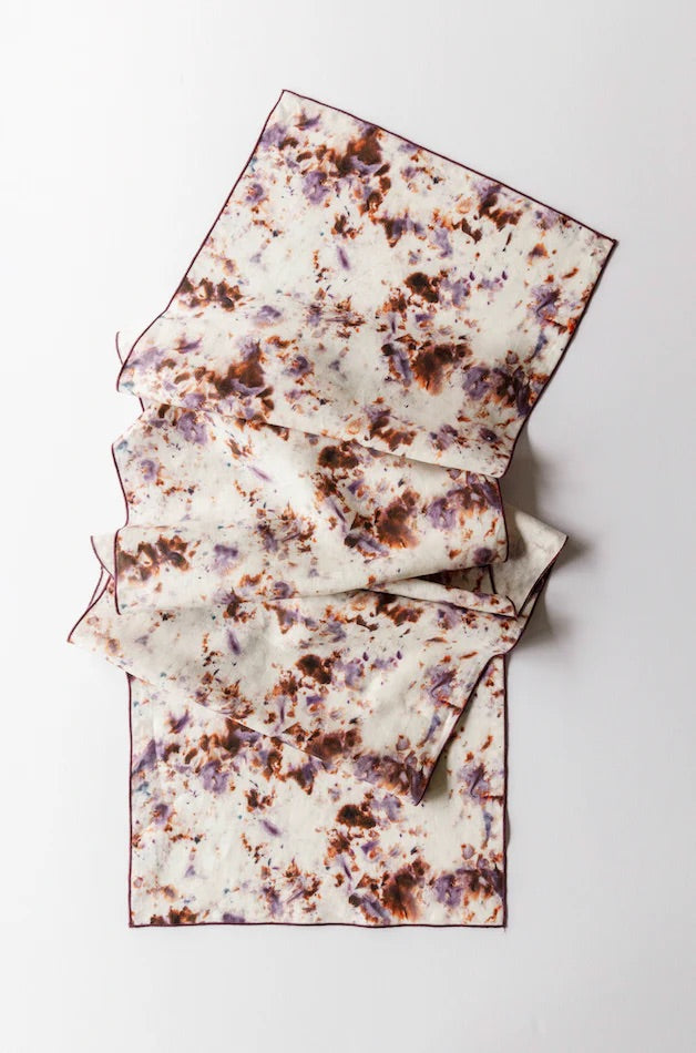 Folded table runner with marble pattern on a white background