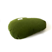 Green pillow with a label on a white background
