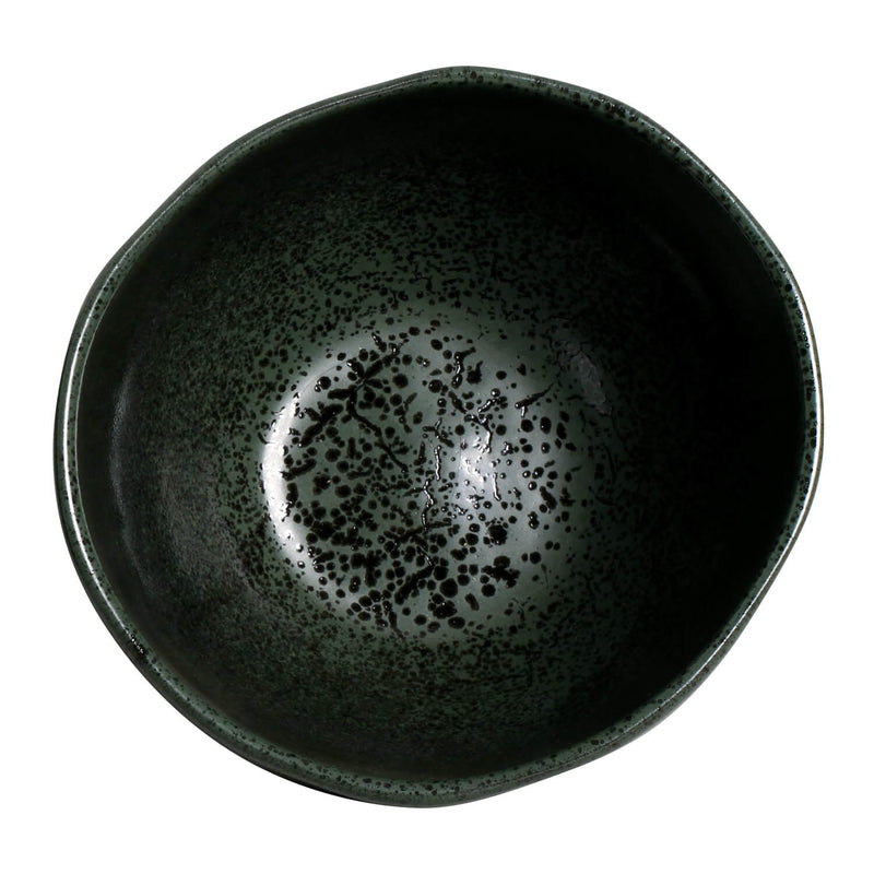 Green ceramic bowl with speckled pattern on a white background