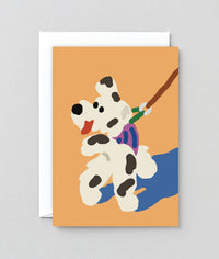 Greeting card with an illustrated dog on a leash against an orange background