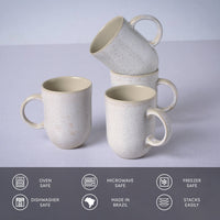 Set of four ceramic mugs with speckled finish on a light gray background, featuring icons and text about safety and features.