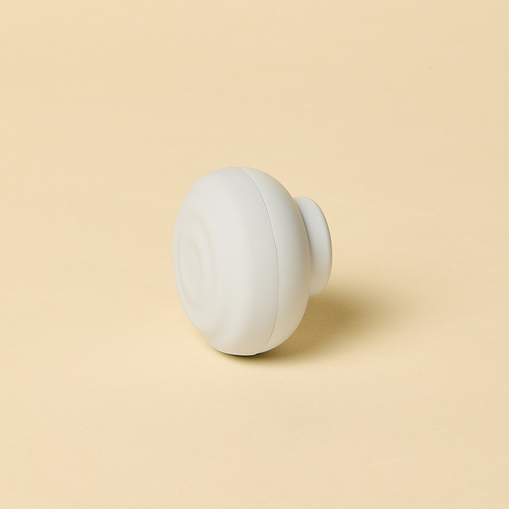 White spherical object on a beige background