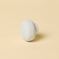 White spherical object on a beige background
