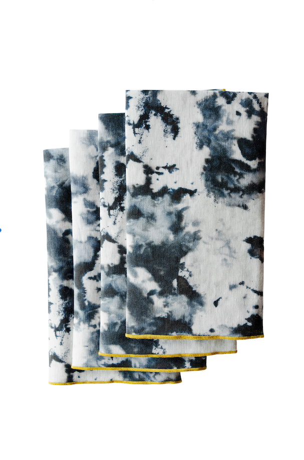 Set of four tie-dye patterned napkins with a white background