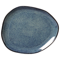 Blue ceramic plate with speckled texture on a white background