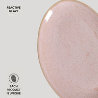 Close-up of a ceramic product with reactive glaze on a light gray background