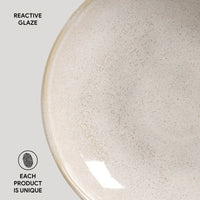 Close-up of a ceramic plate with reactive glaze on a light gray background