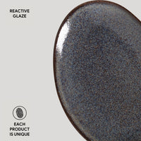 Close-up of a ceramic plate with reactive glaze on a gray background