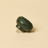 Green plug on a beige background