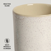 Ceramic vase with reactive glaze finish on a light gray background