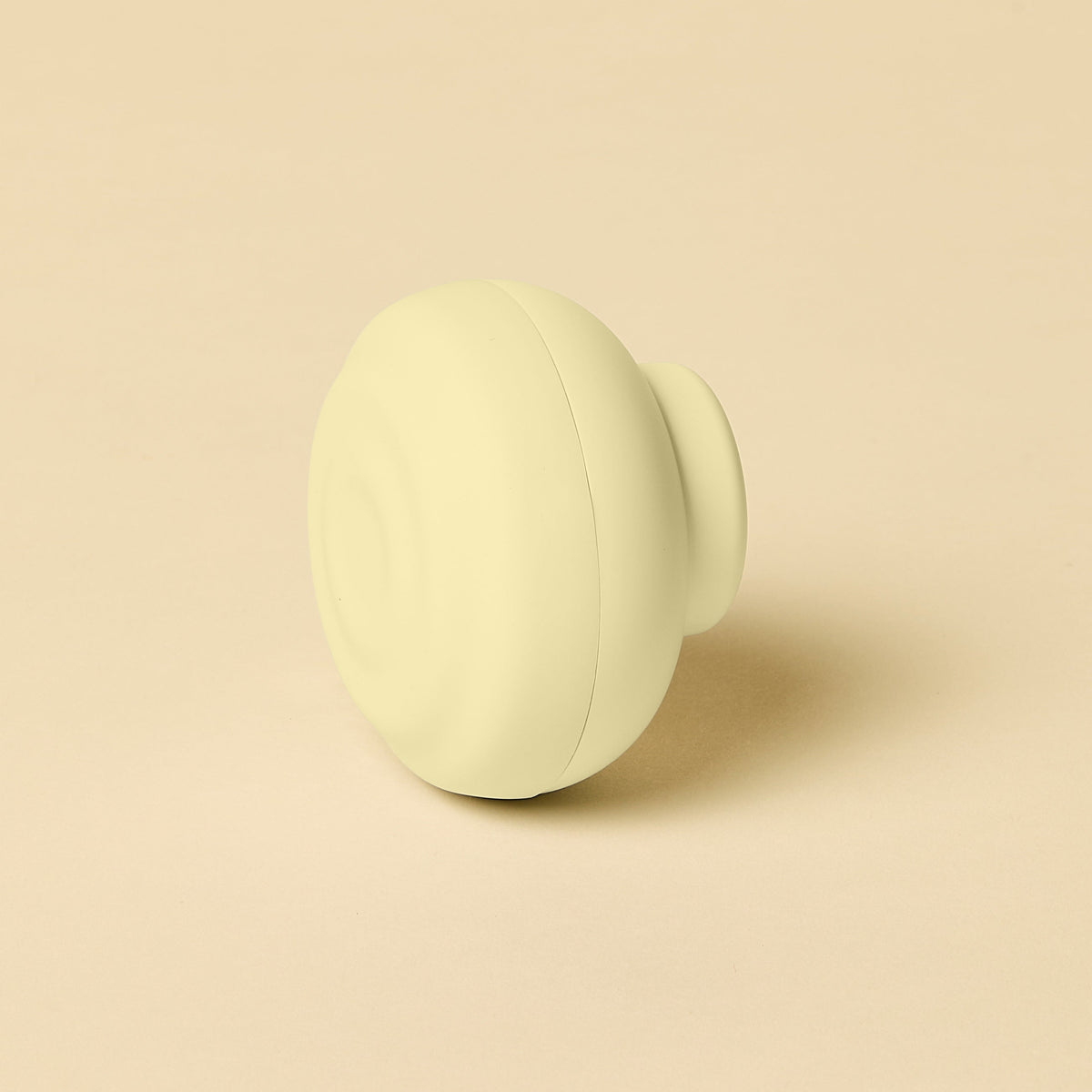 Light yellow sphere on a beige background