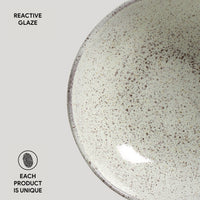 Ceramic plate with reactive glaze on a light gray background